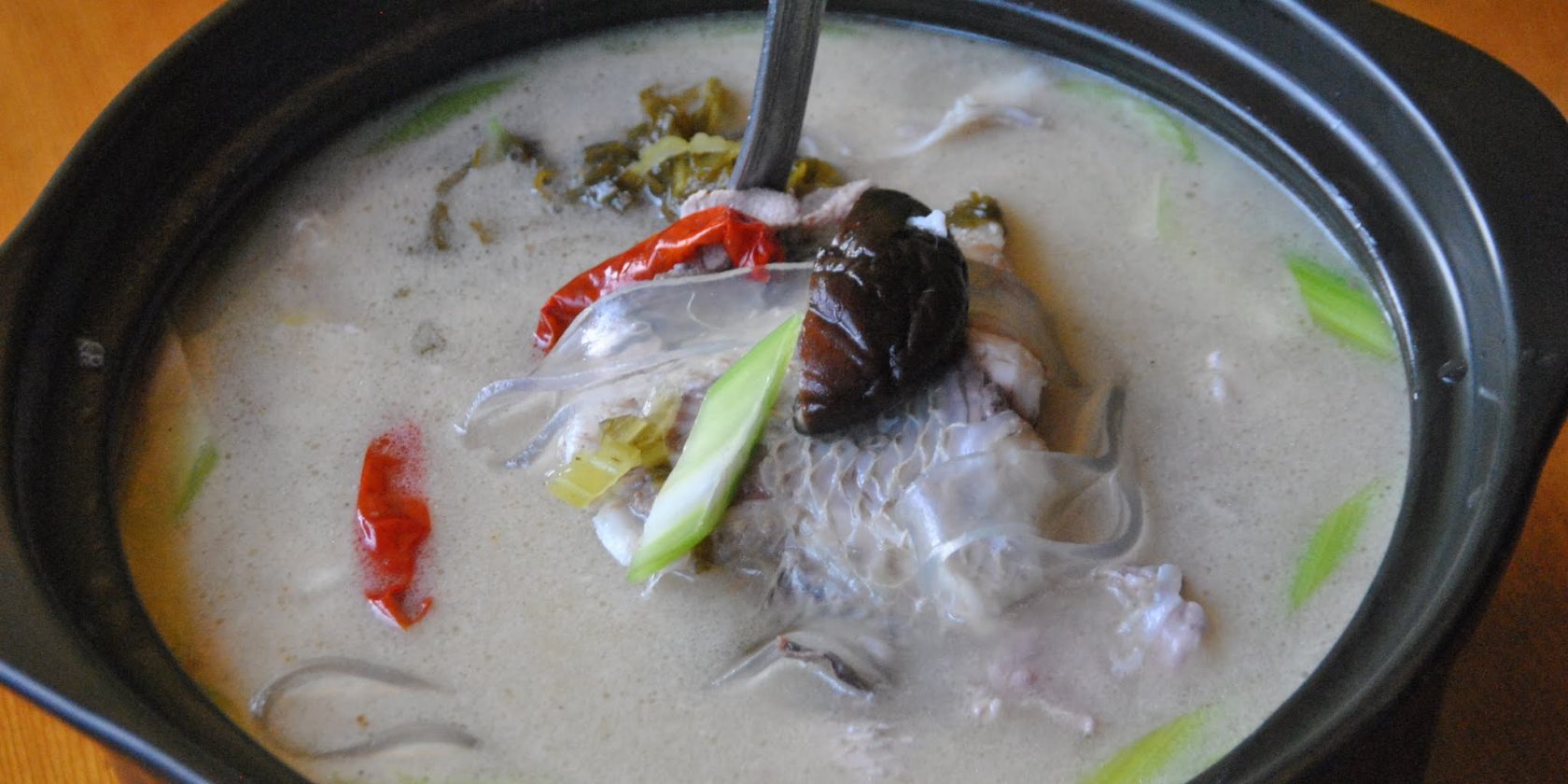 S8. 酸菜粉皮全鱼砂锅 	Pickled Cabbage with Tilapia in Hot Pot